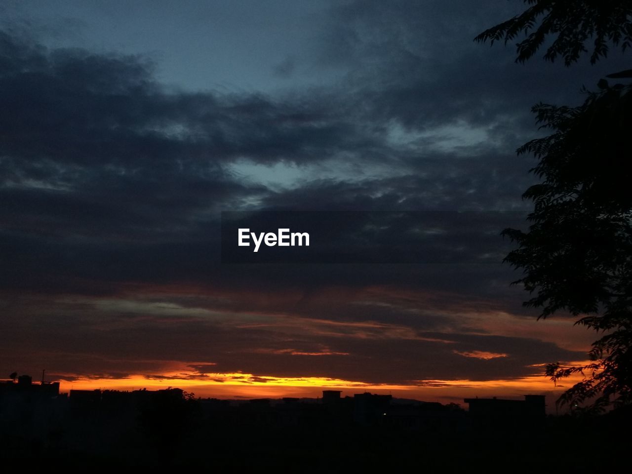 SILHOUETTE OF LANDSCAPE AGAINST DRAMATIC SKY