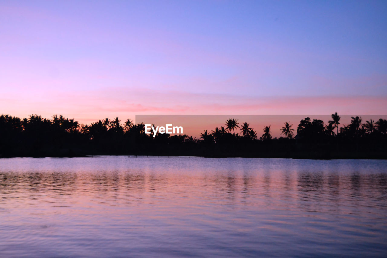 Scenic view of lake against sky during sunset