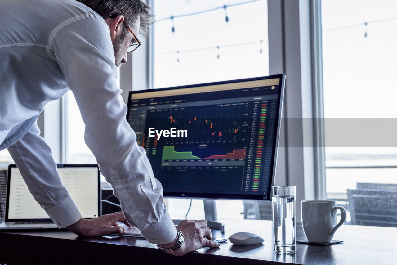 Man looking at computer screen data.