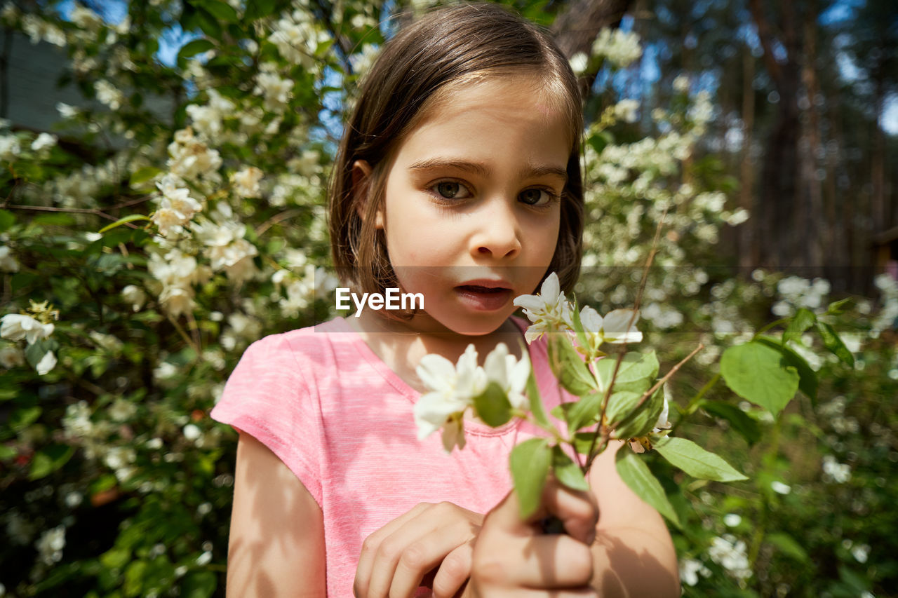 Portrait of cute girl with plants