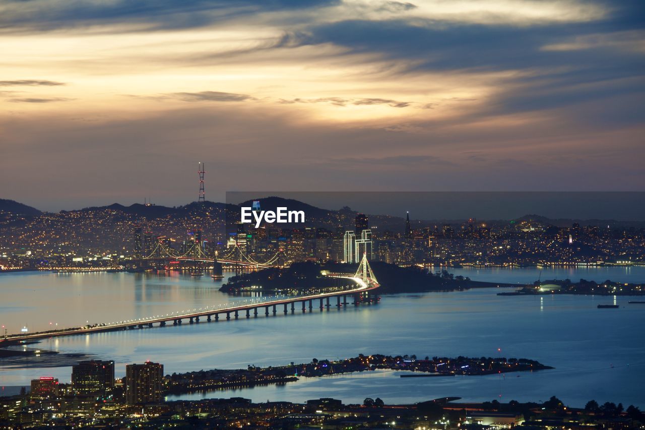 High angle view of illuminated city at waterfront