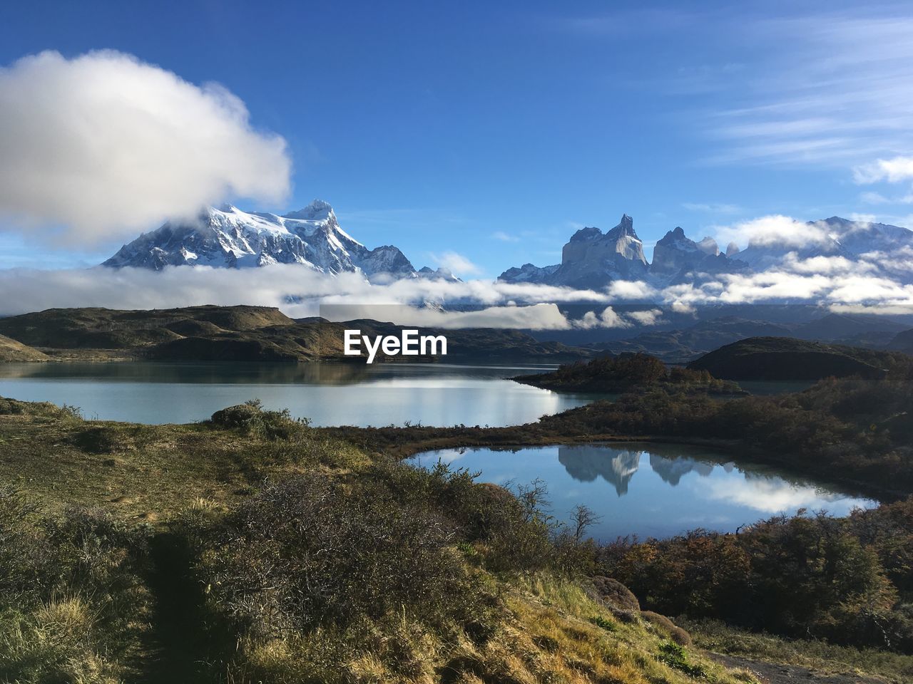 Scenic view of lake and mountains against sky