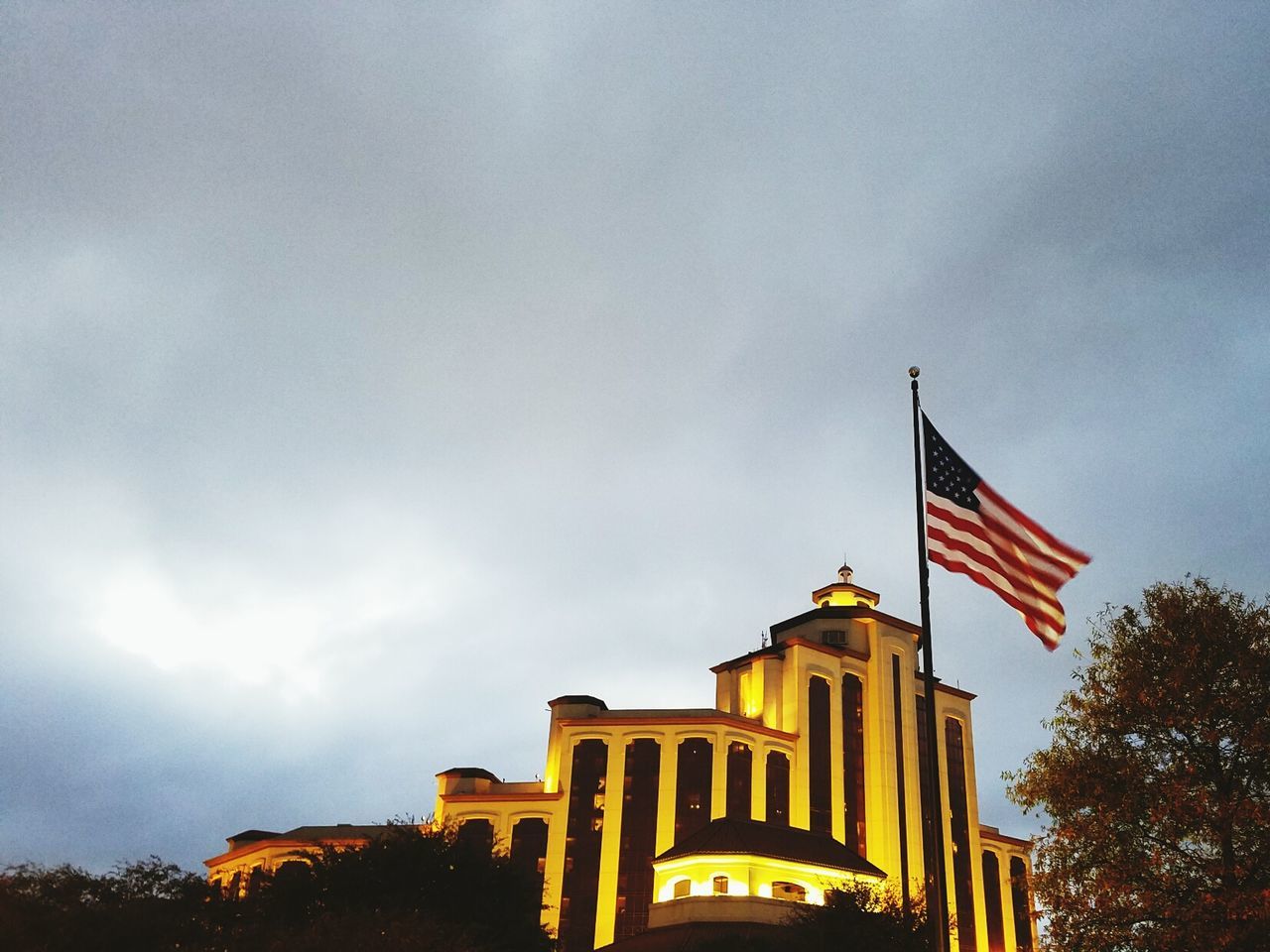 LOW ANGLE VIEW OF FLAGS AGAINST BUILDING