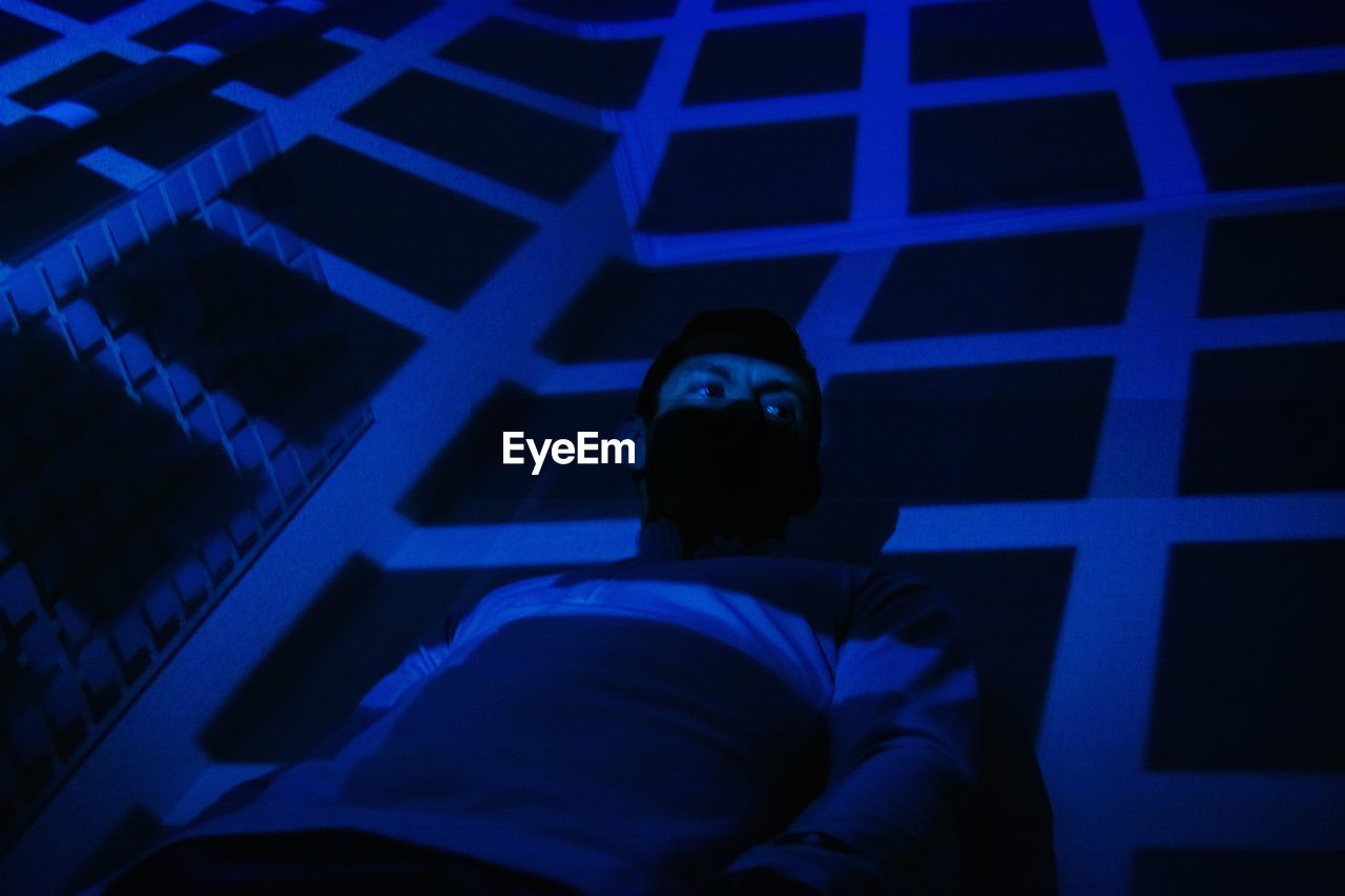 Man in illuminated room
