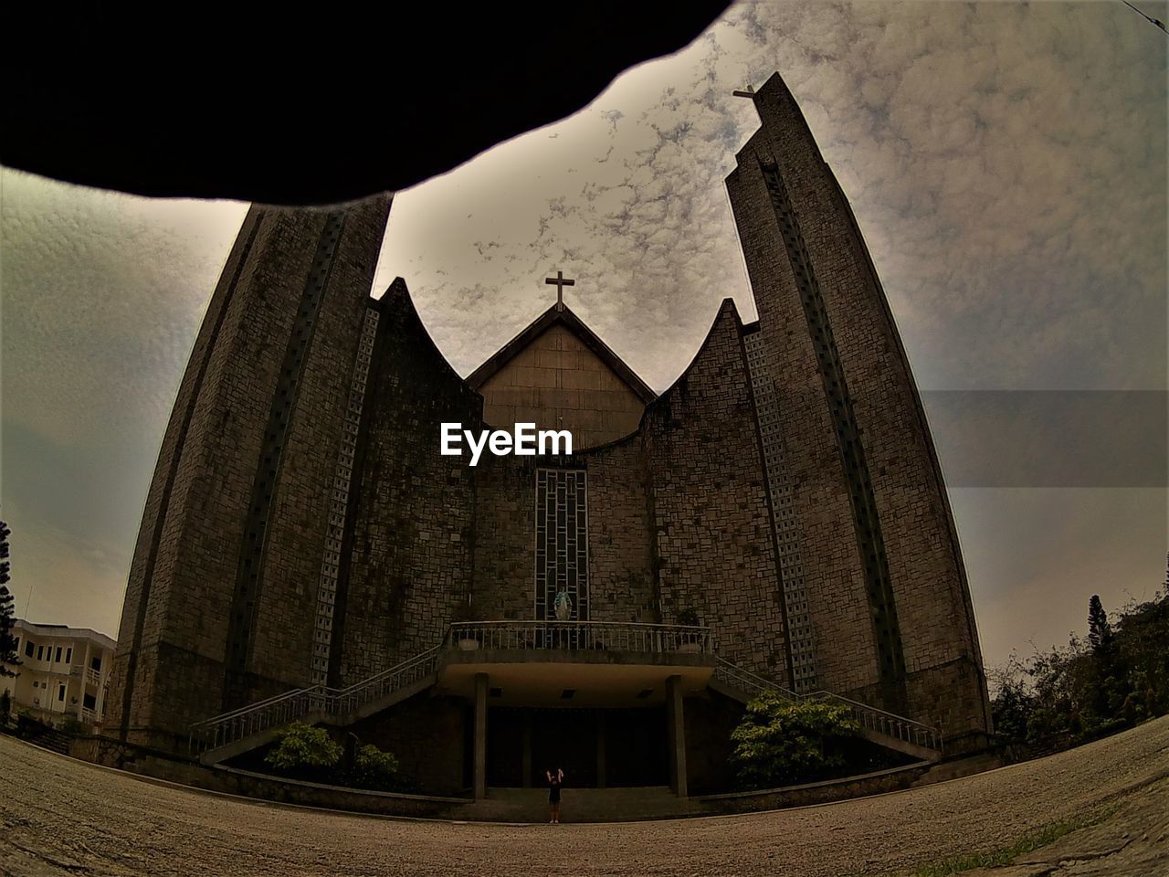 MAN BY TEMPLE AGAINST SKY