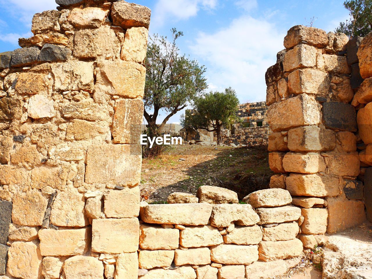 LOW ANGLE VIEW OF STONE WALL AGAINST SKY