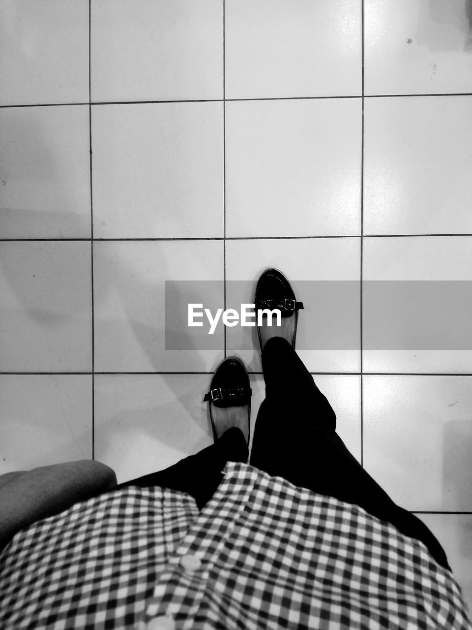 Low section of woman walking on floor