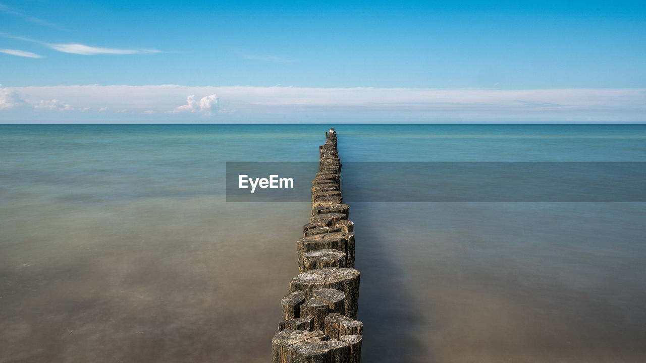 High angle view of wooden posts in sea