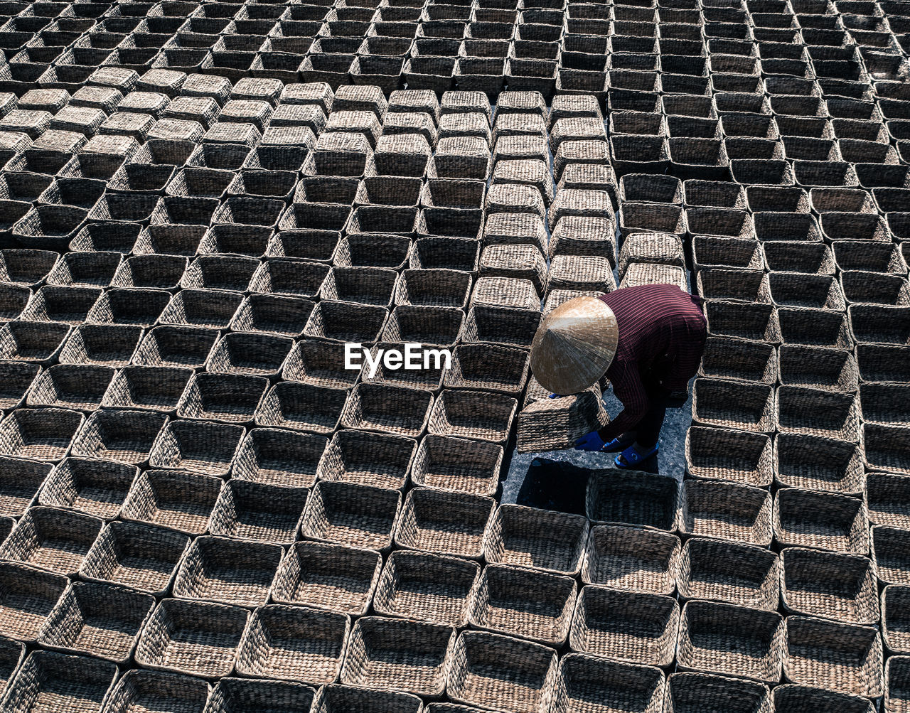 High angle view of farmer arranging baskets