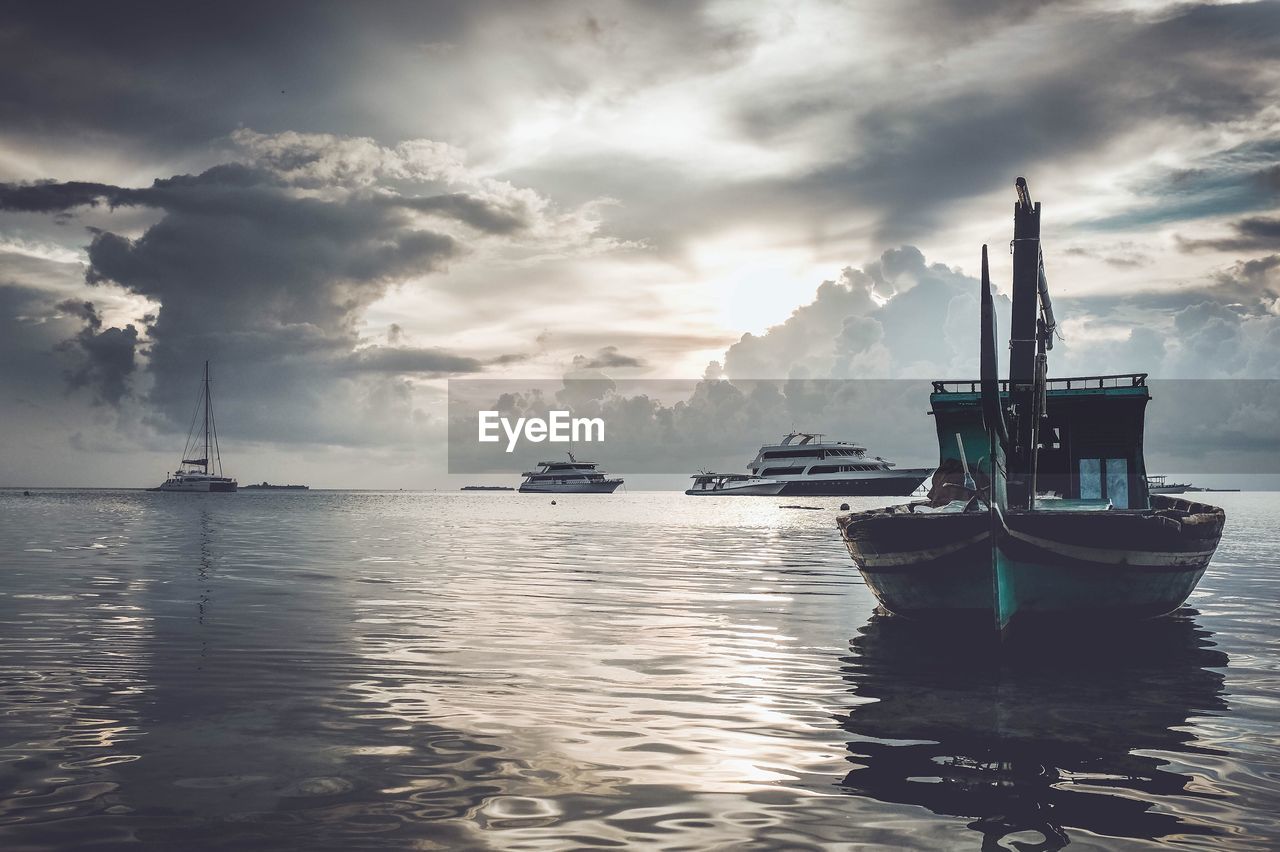 Dramatic seascape with boats against cloudy sky