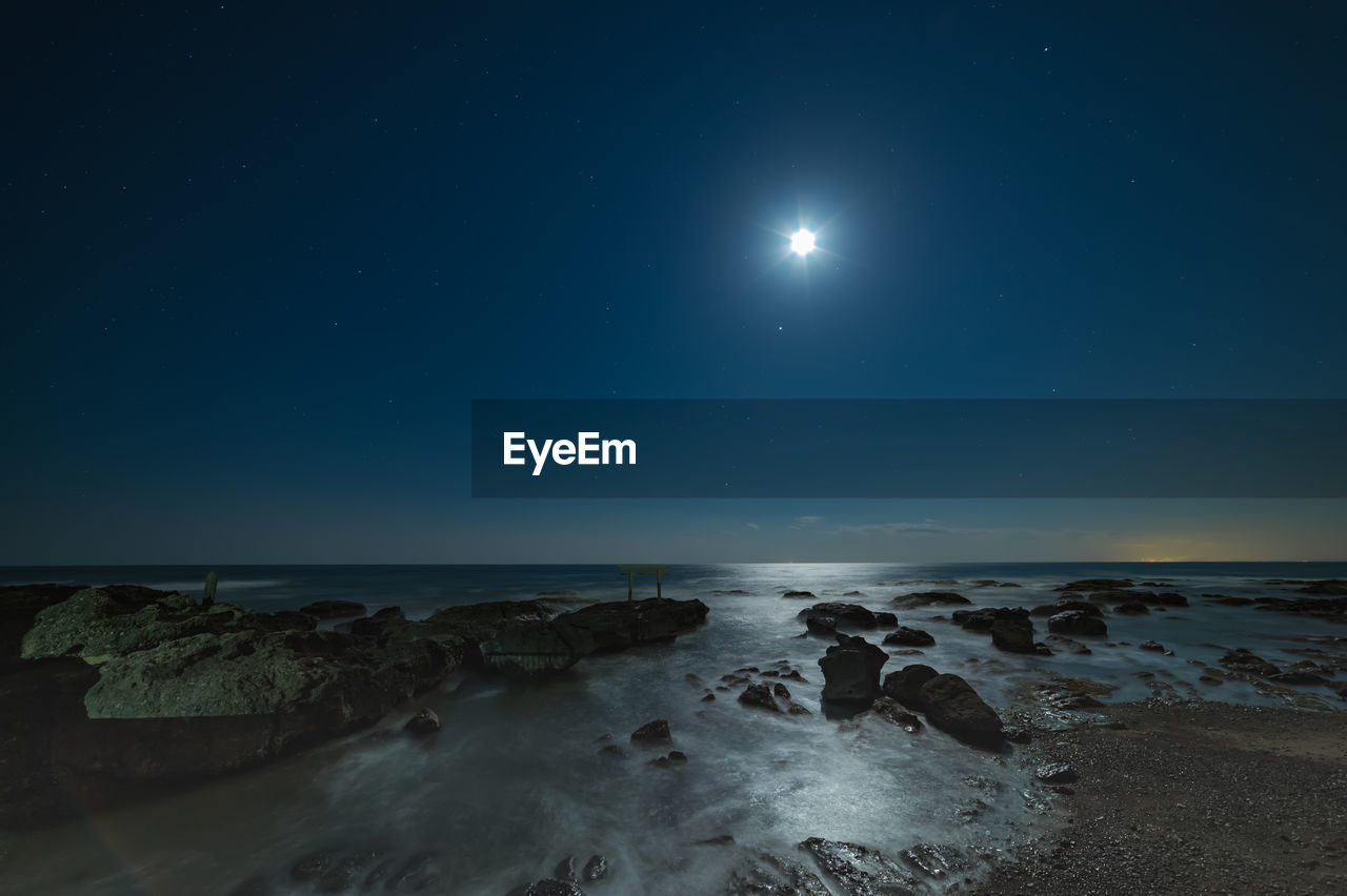 Scenic view of sea against sky at night