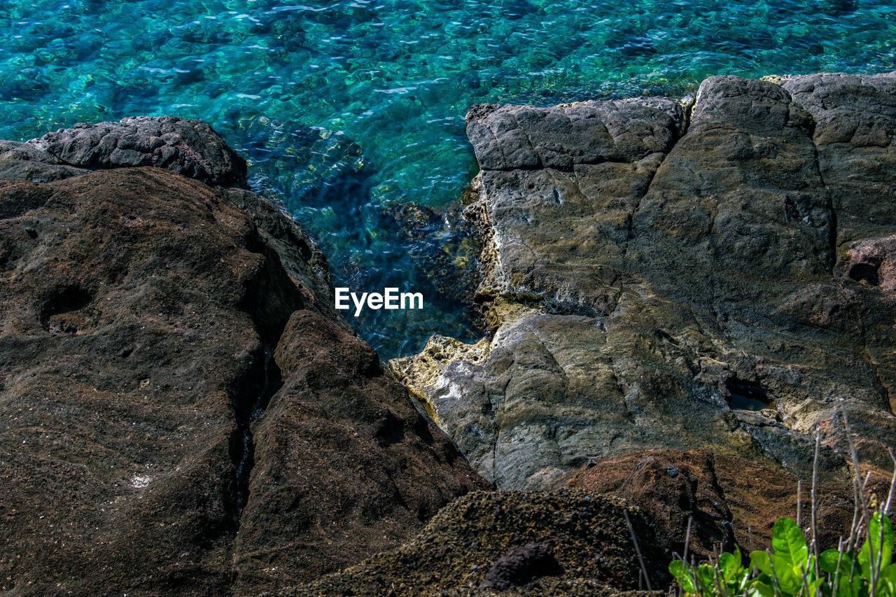 High angle view of rock formation in sea