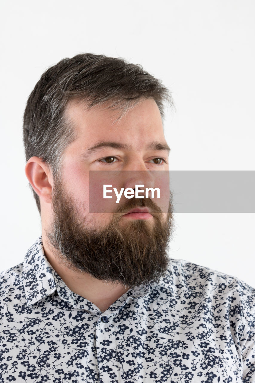 Close-up of man looking away against white background