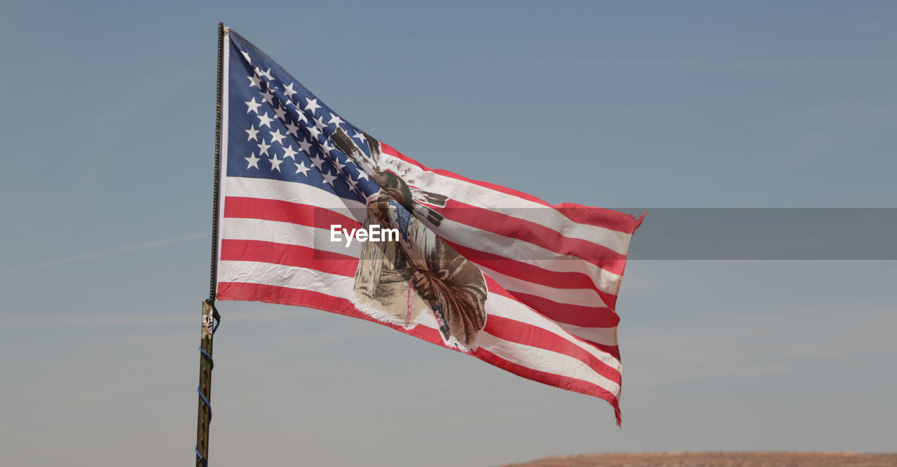 LOW ANGLE VIEW OF FLAGS AGAINST SKY