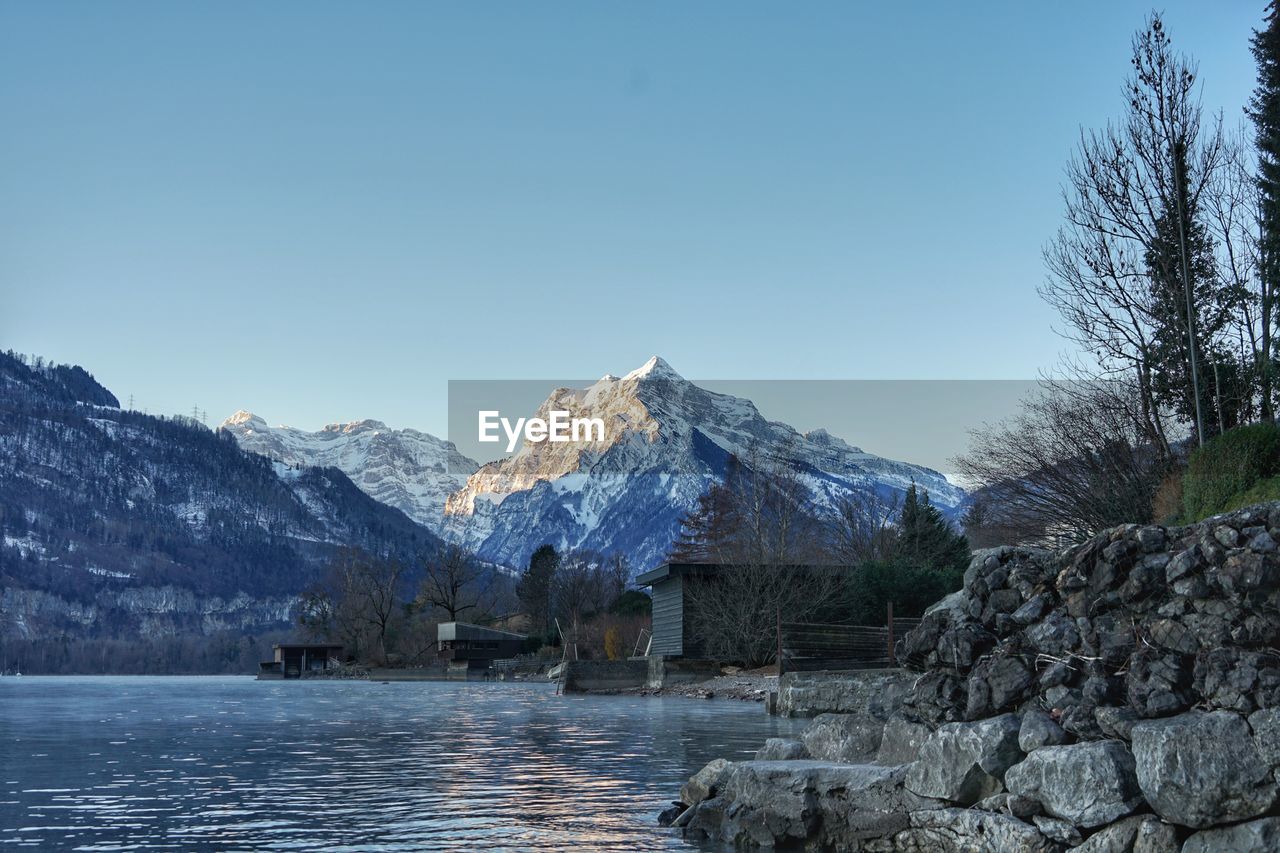 Scenic view of snowcapped mountains against clear sky