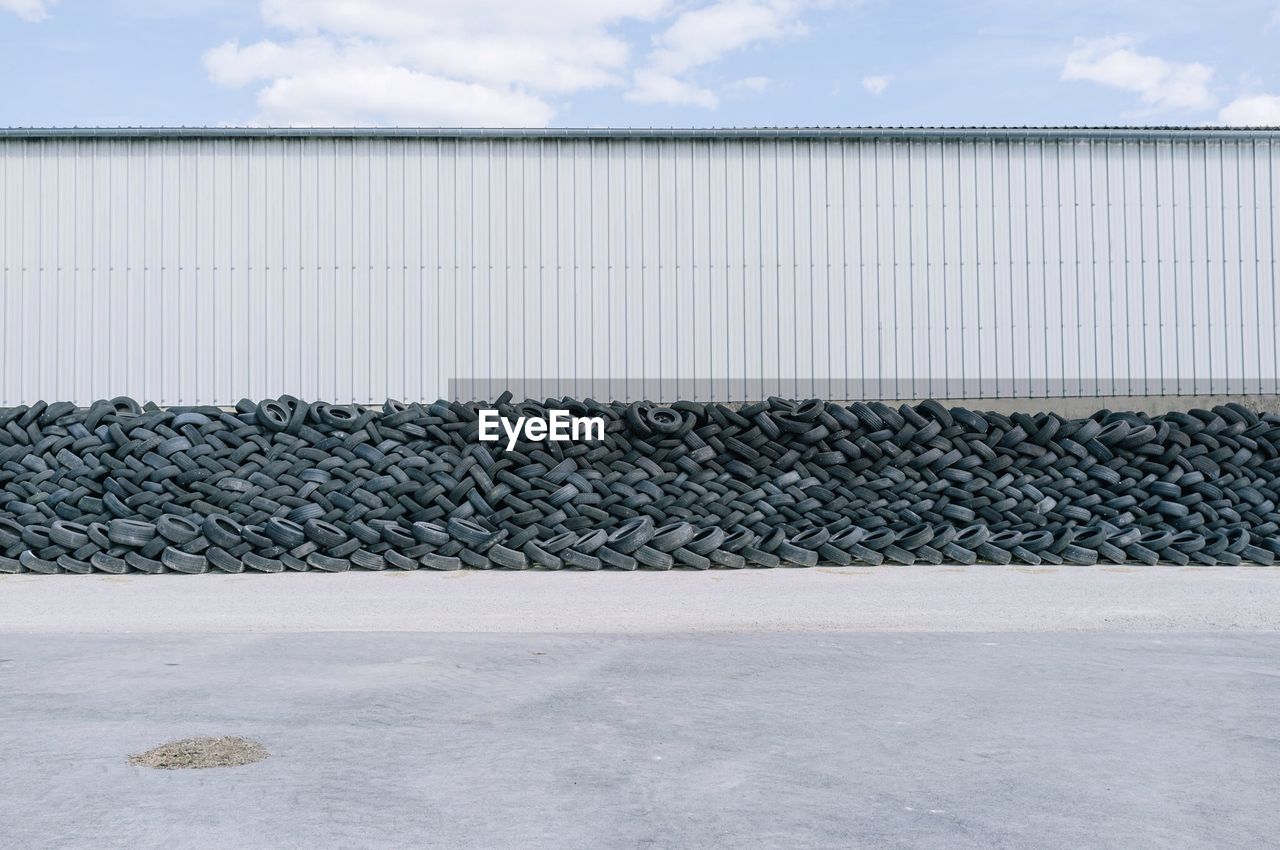 Stack of tyres piled up against wall