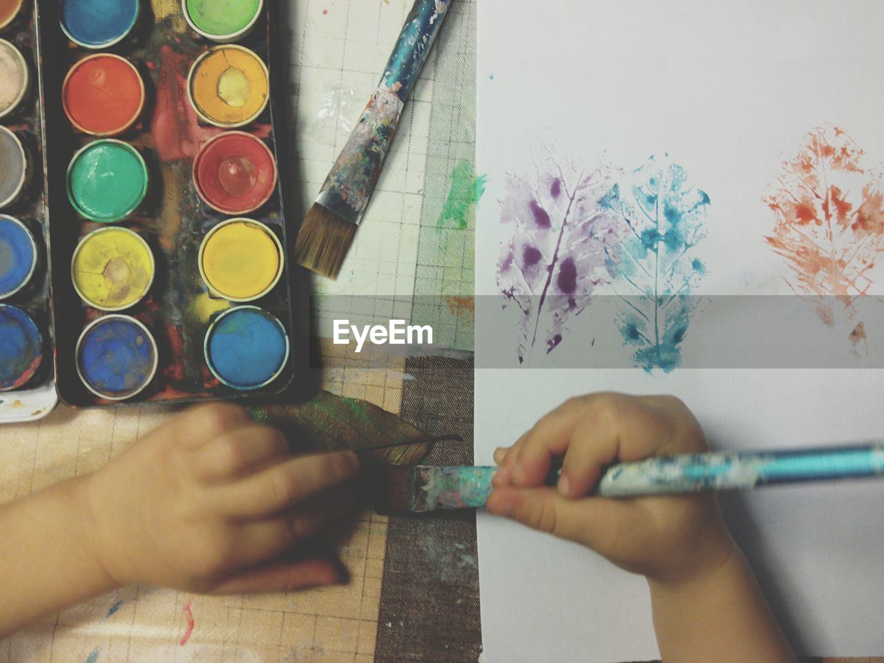 A child painting with watercolors