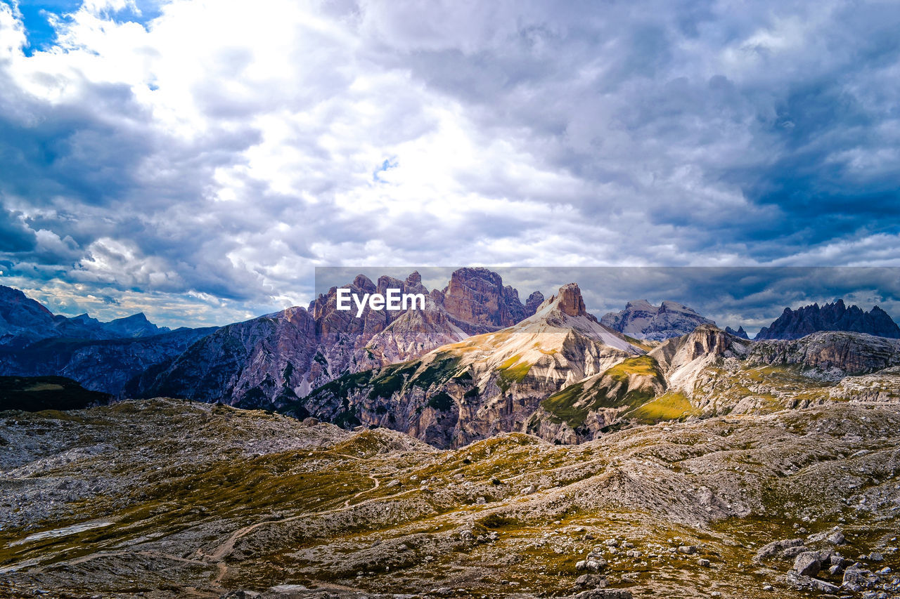 Scenic view of mountains against cloudy sky