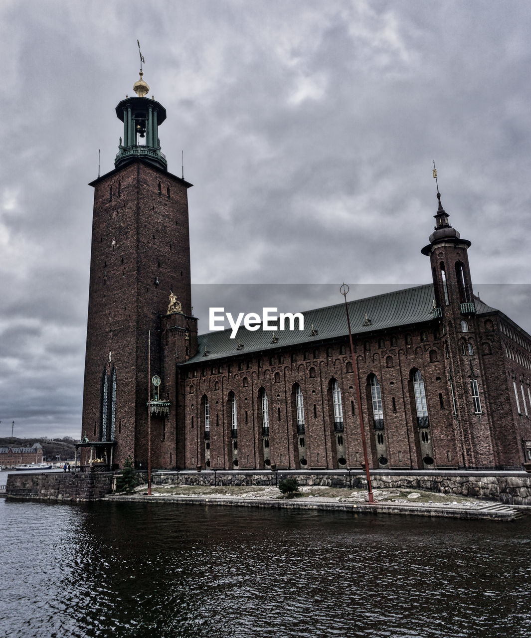 Tower of building against cloudy sky