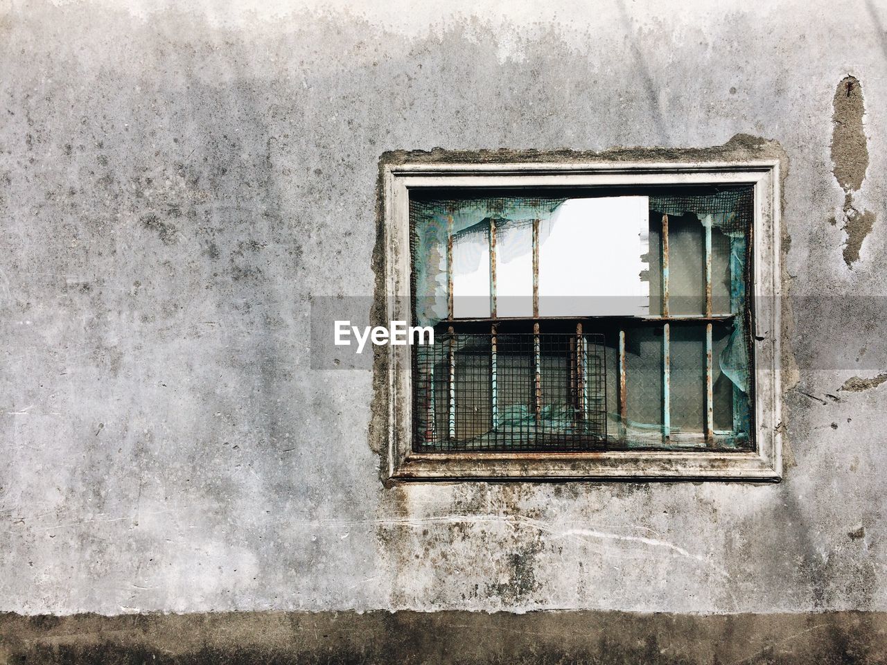 Close-up of abandoned window on old wall