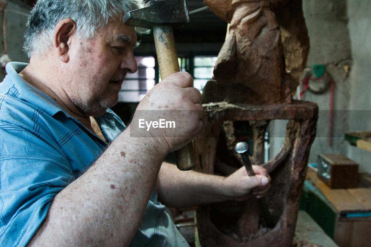 Senior man working at workshop