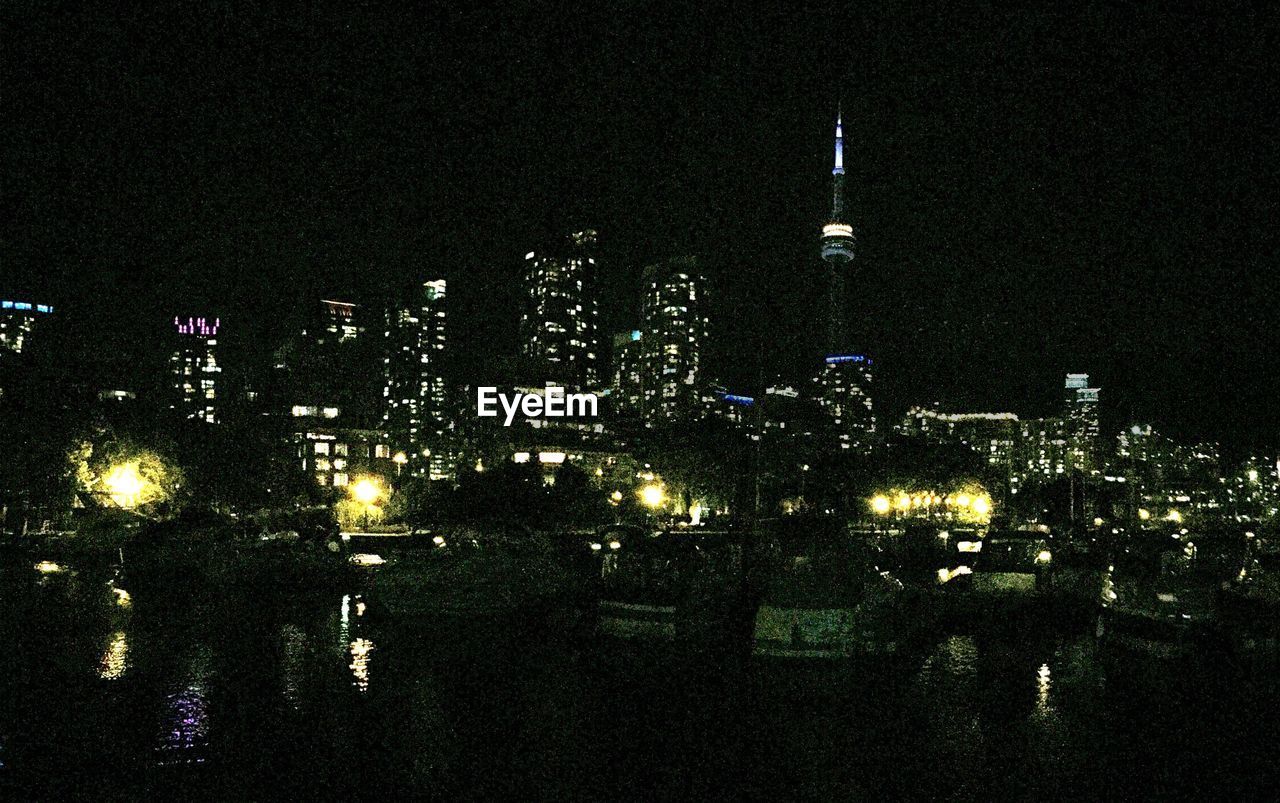 VIEW OF ILLUMINATED CITYSCAPE AT NIGHT