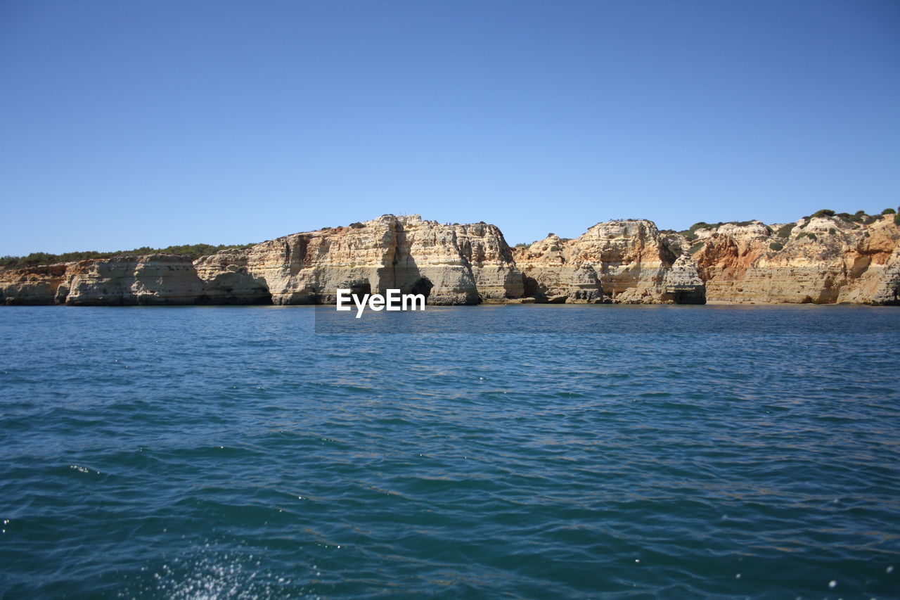 Scenic view of sea against clear blue sky