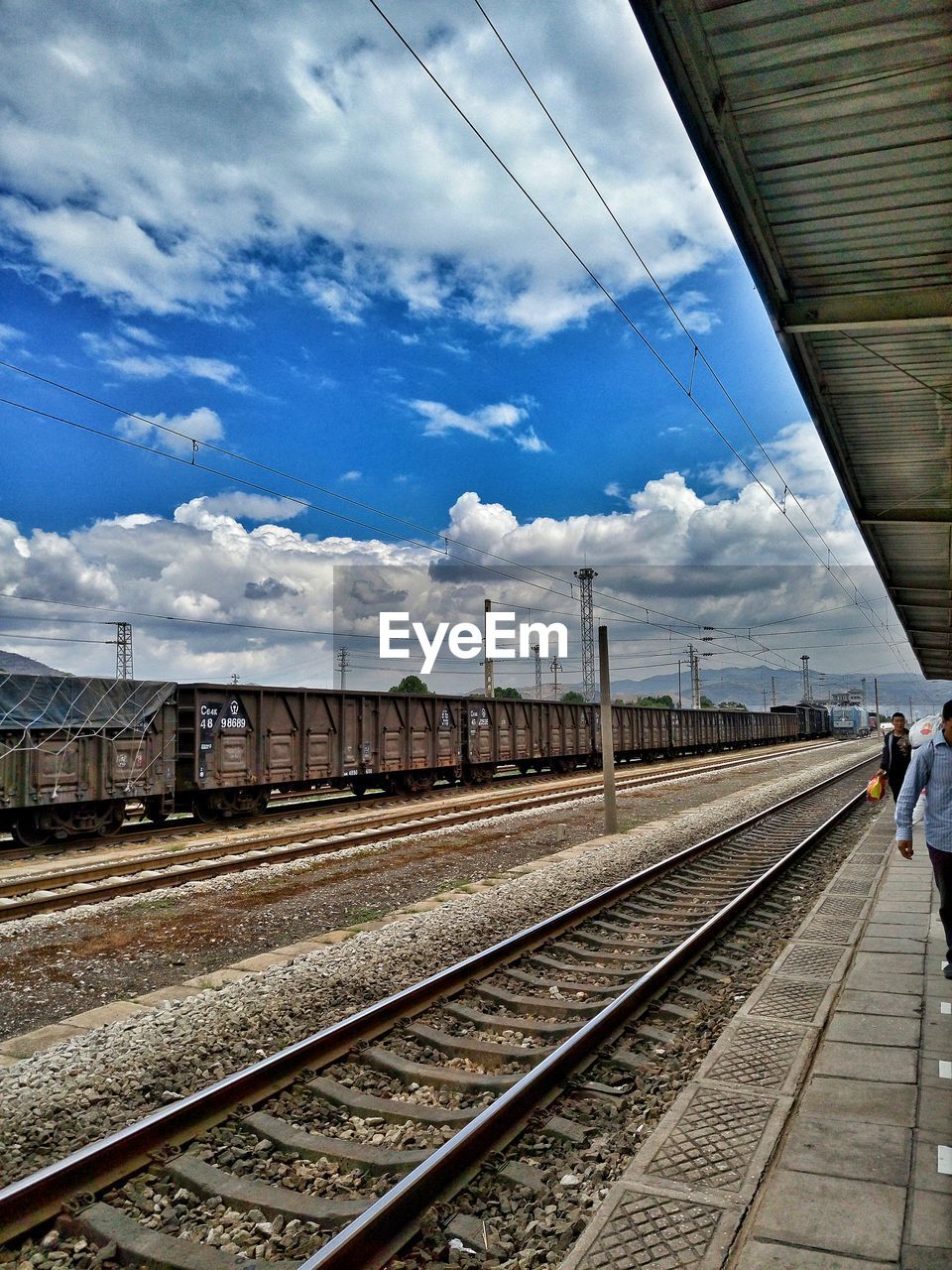 RAILROAD TRACKS ON RAILROAD STATION PLATFORM