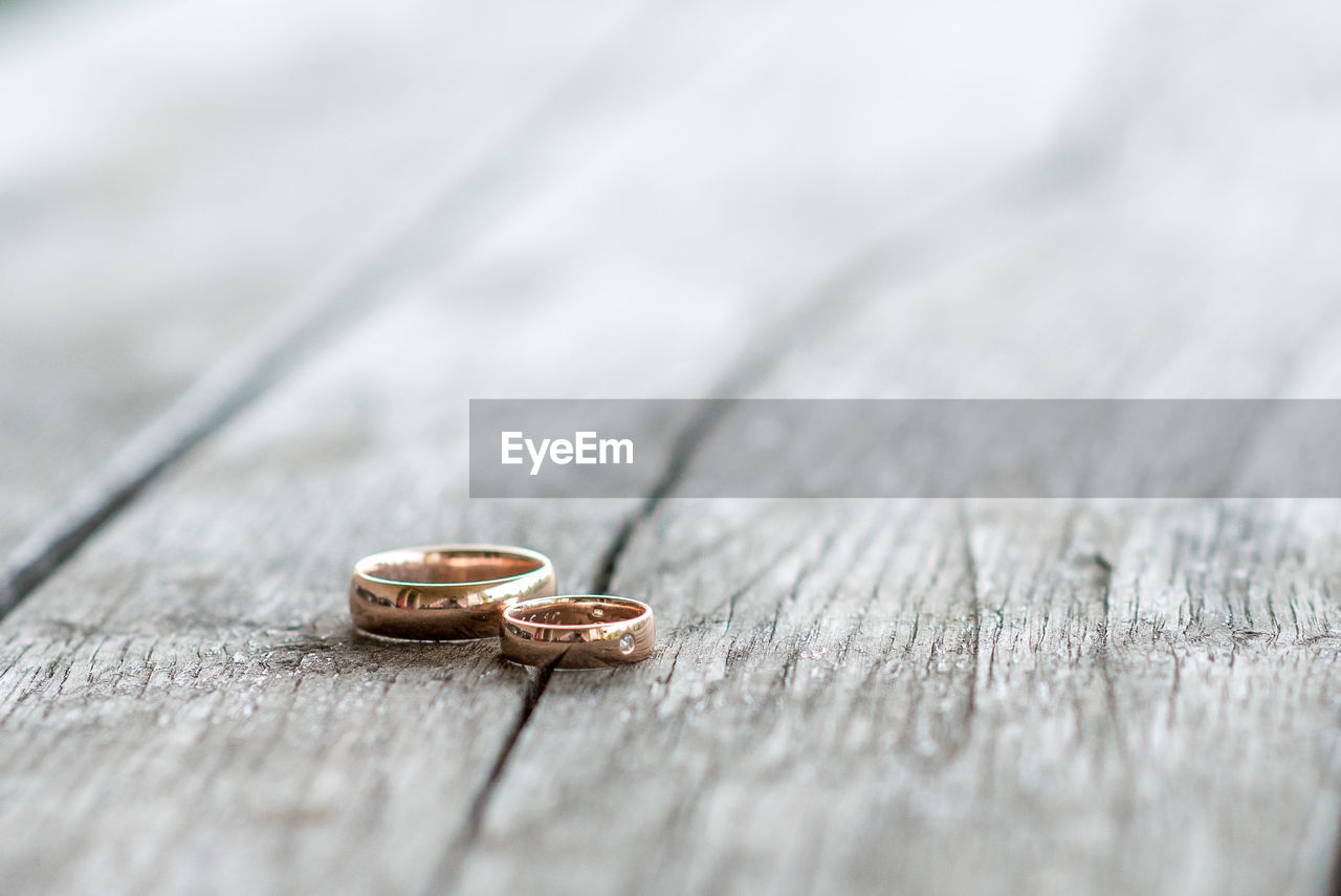 Close-up wedding rings on the wooden table