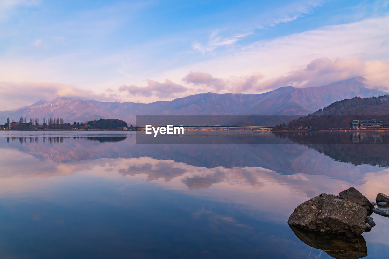 Scenic view of lake and mountains against sky