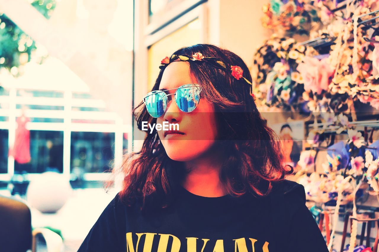 Girl wearing sunglasses and tiara in store