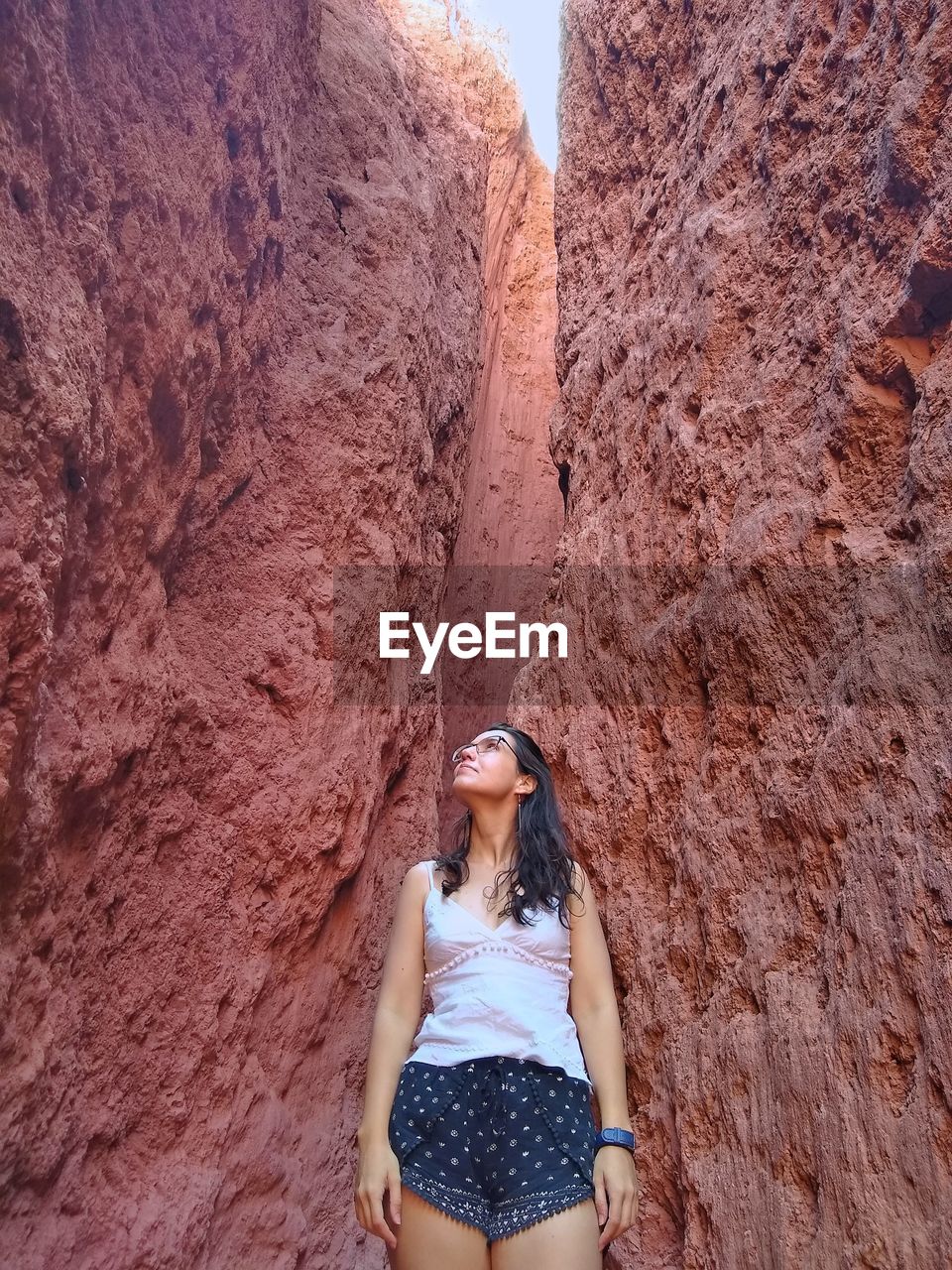 Young woman standing amidst rock formations