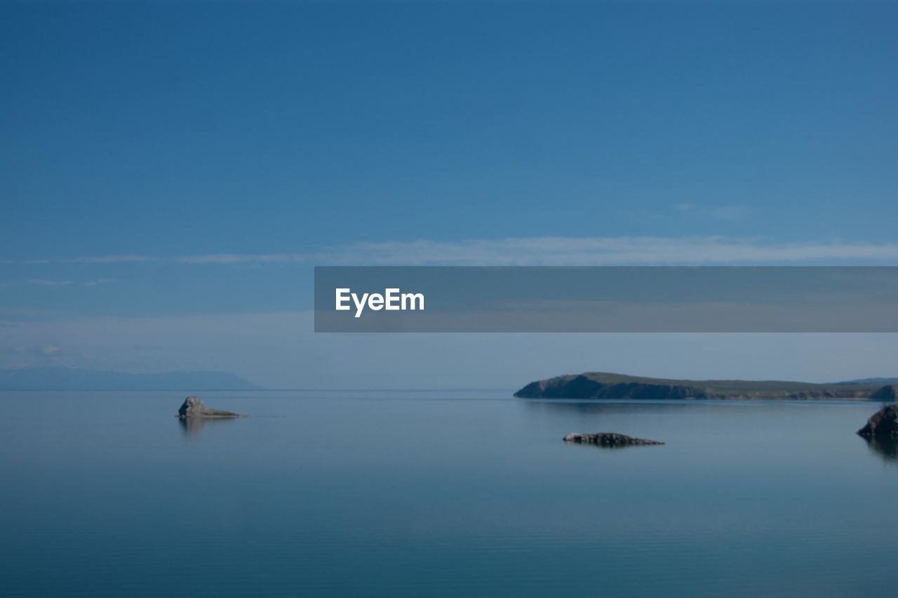 Scenic view of sea against blue sky