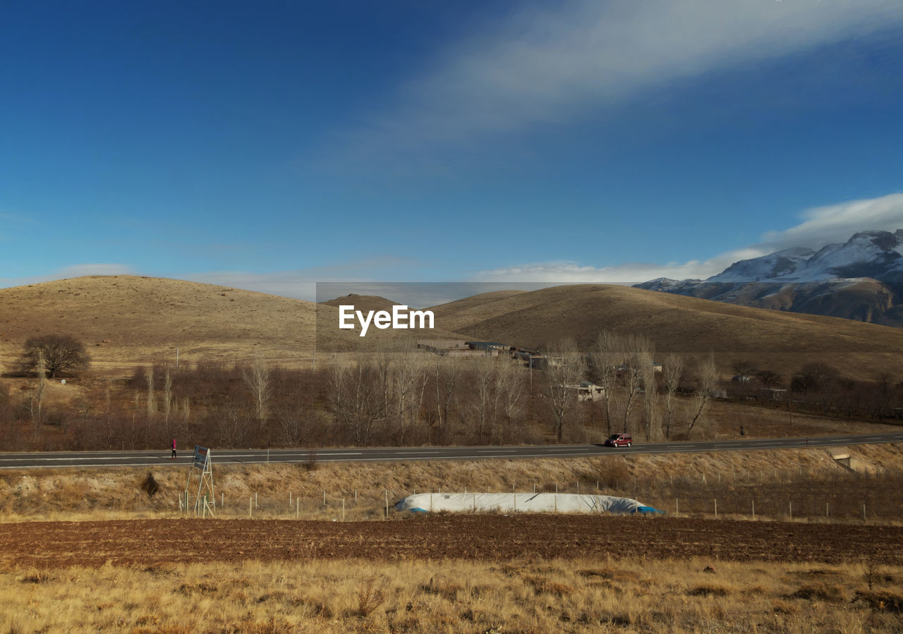 Scenic view of landscape against blue sky