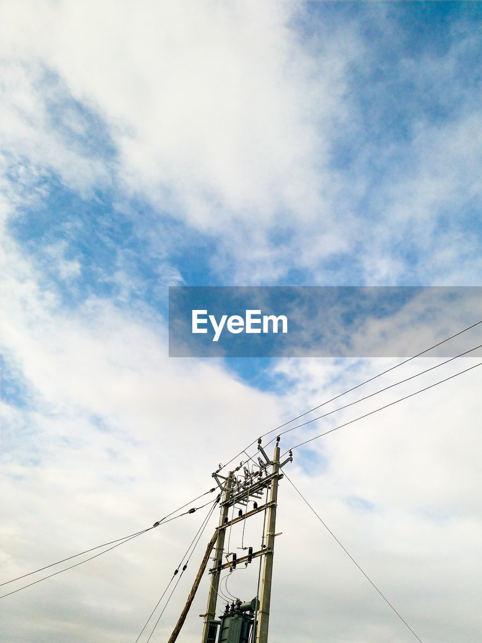 Low angle view of electricity pylon against sky