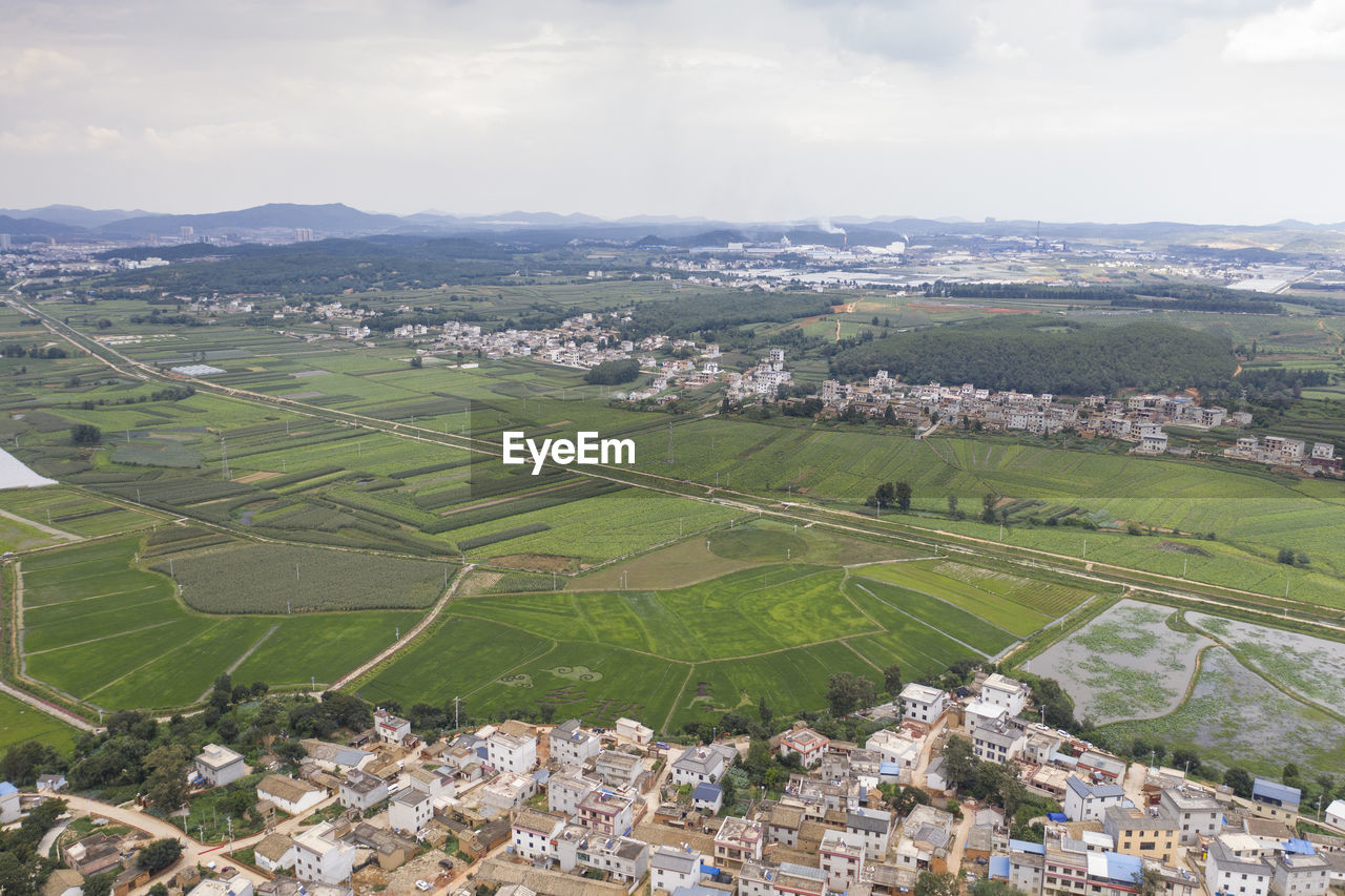 AERIAL VIEW OF TOWNSCAPE BY CITY AGAINST SKY