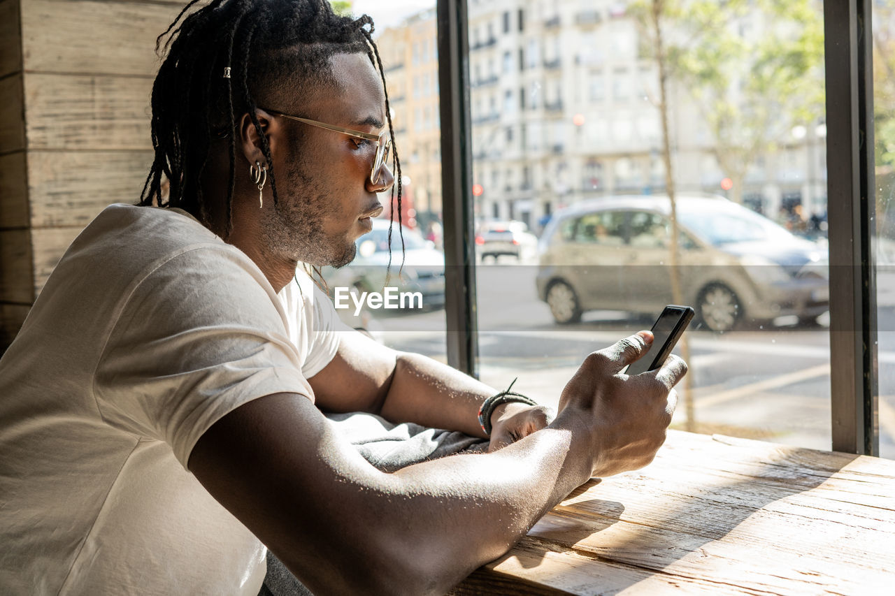 Man using mobile phone at table