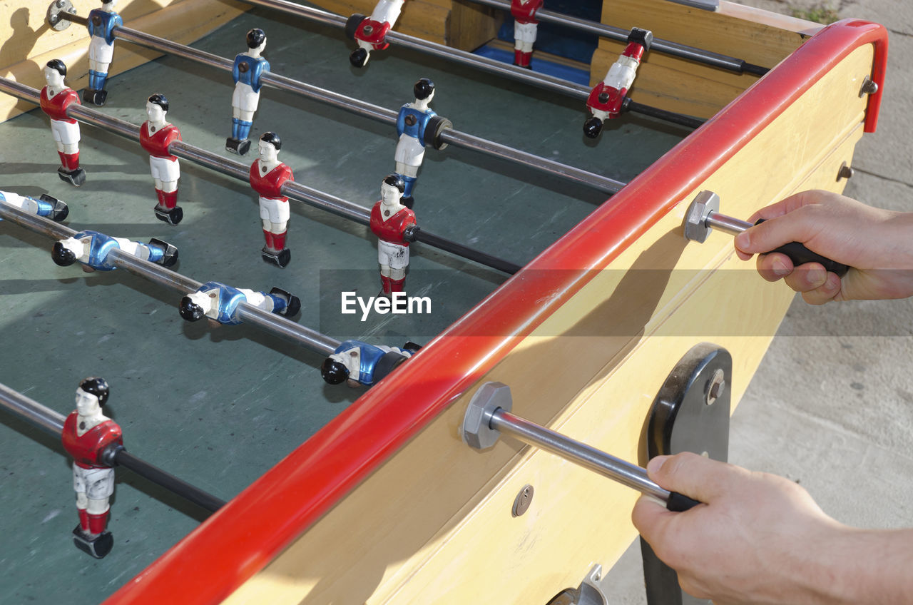 High angle view of person playing foosball