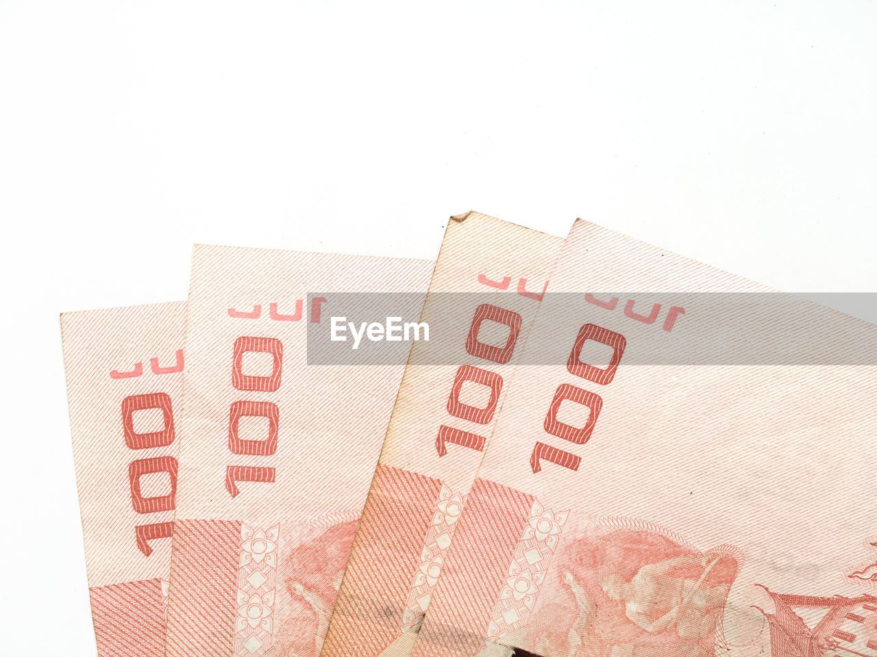 CLOSE-UP OF RED PAPER OVER WHITE BACKGROUND AGAINST GRAY