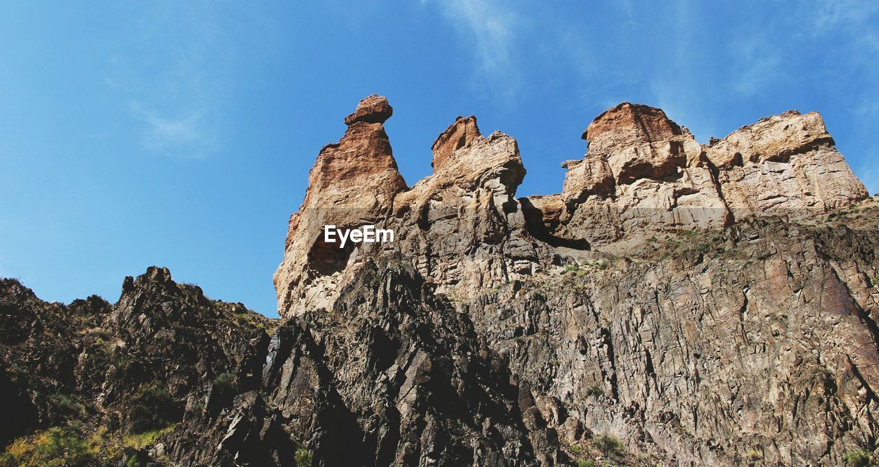 Low angle view of rock formation against sky