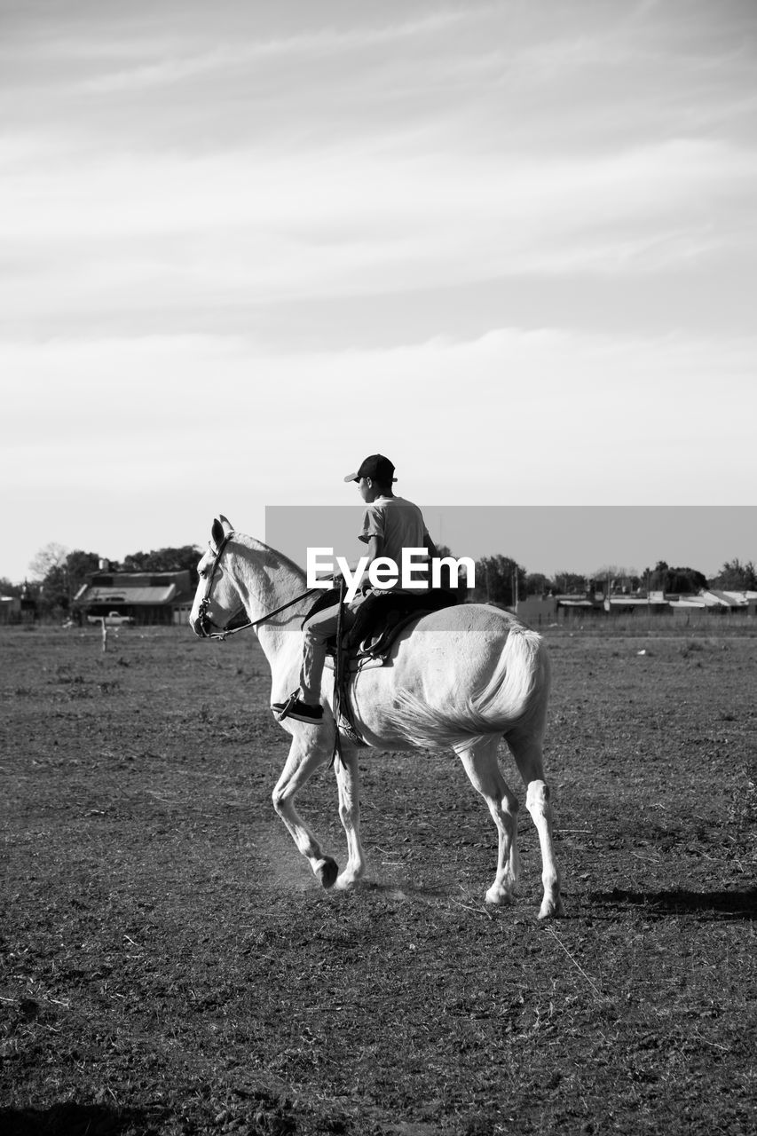 Rural scene boy riding horse