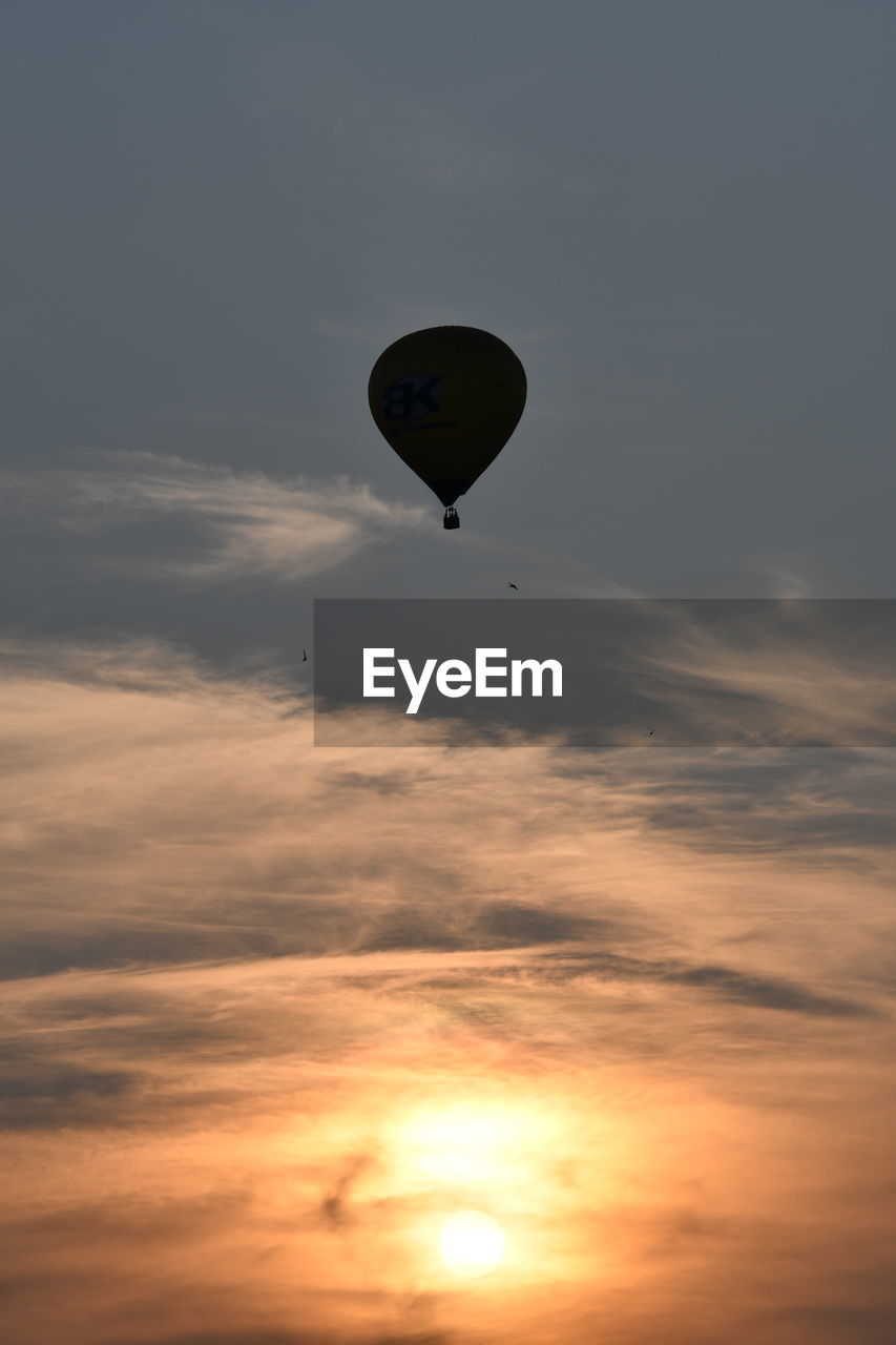 LOW ANGLE VIEW OF HOT AIR BALLOON AGAINST SKY AT SUNSET