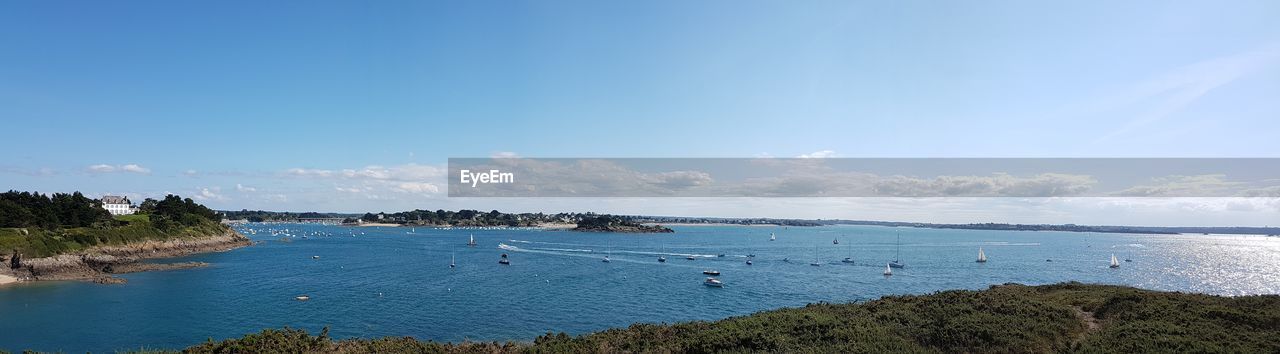 SCENIC VIEW OF BEACH AGAINST BLUE SKY