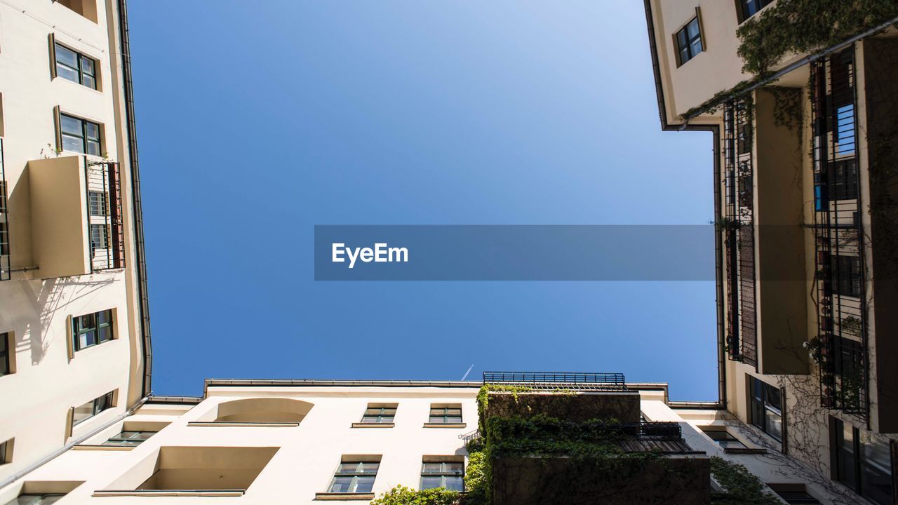 LOW ANGLE VIEW OF BUILDINGS AGAINST CLEAR SKY