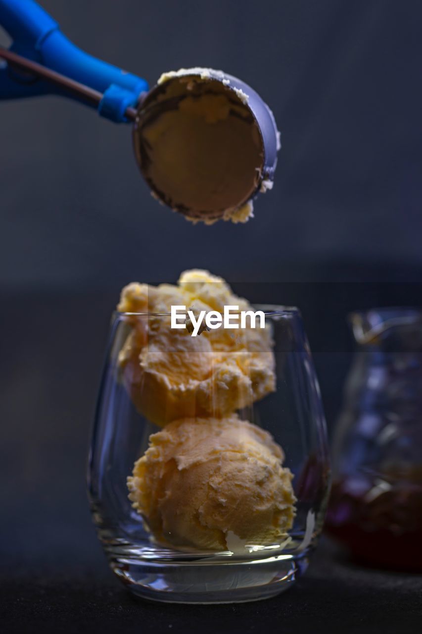 CLOSE-UP OF ICE CREAM ON GLASS TABLE