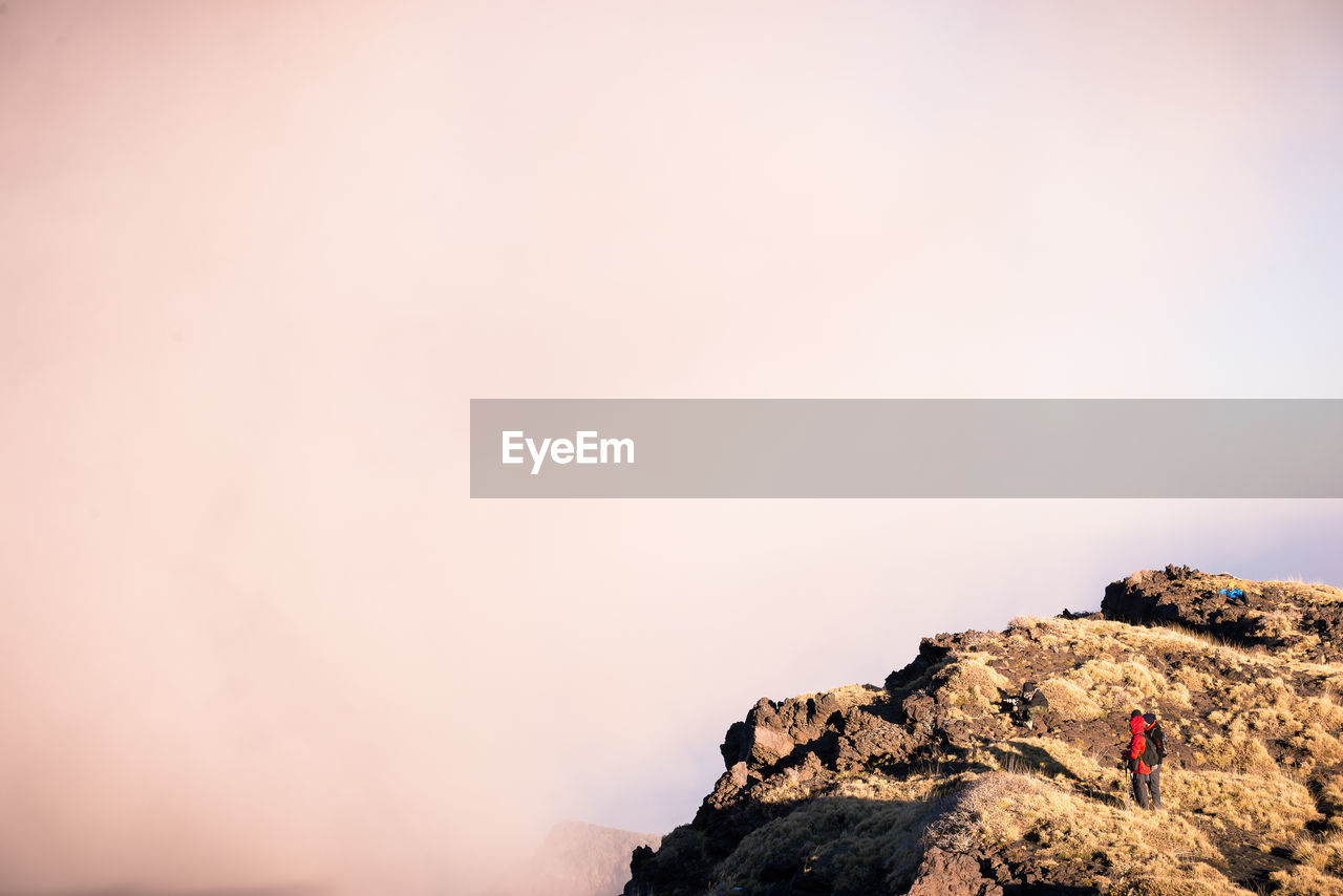 ROCKS ON MOUNTAIN AGAINST SKY