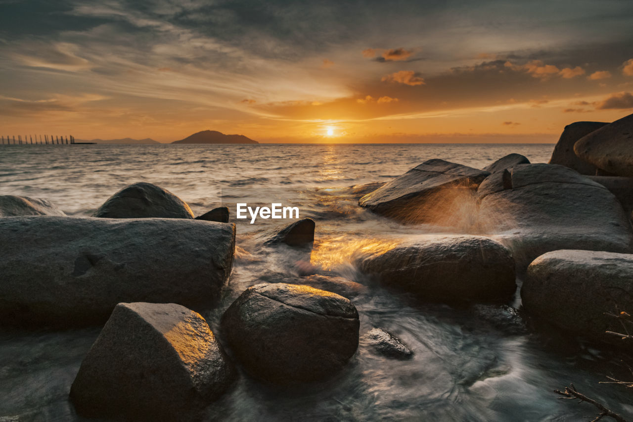 Scenic view of sea against sky during sunset