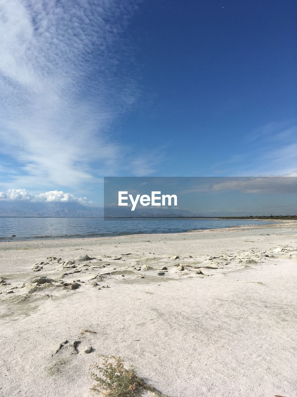 Scenic view of beach against blue sky