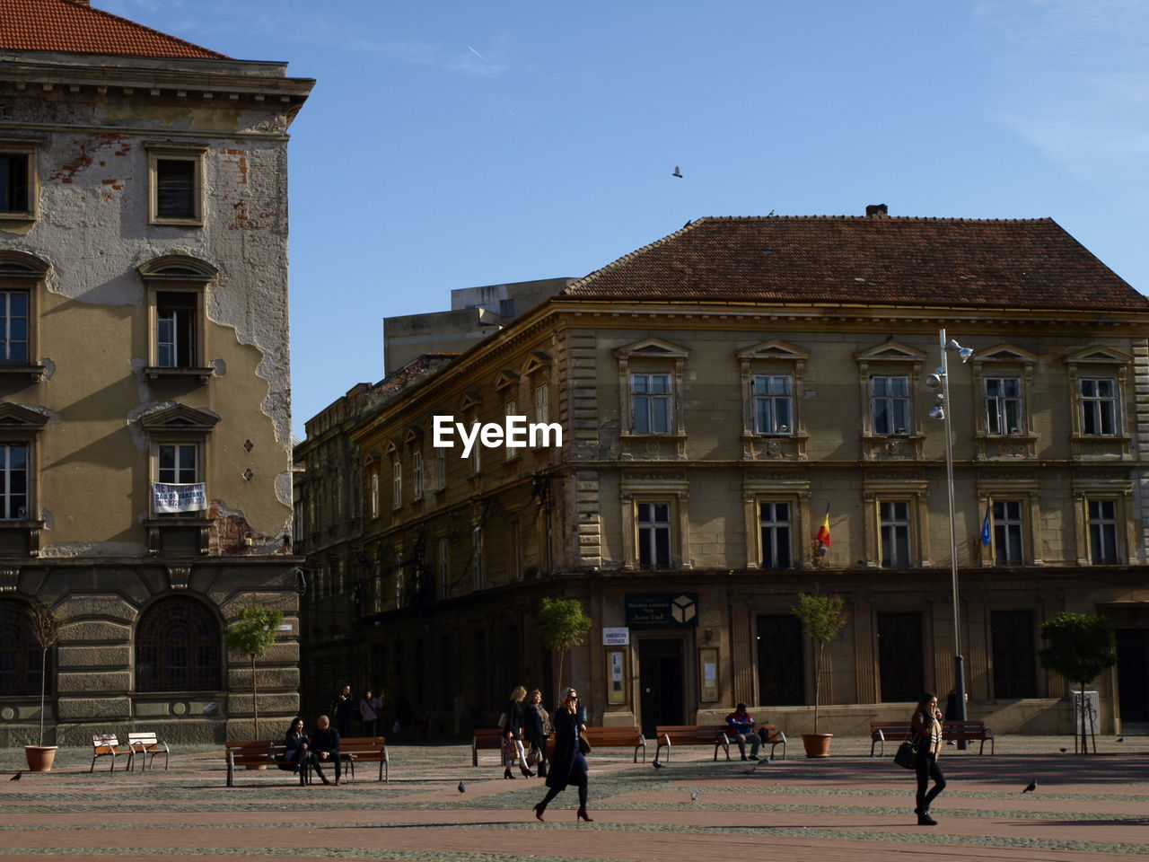 PEOPLE ON BUILDING AGAINST CLEAR SKY