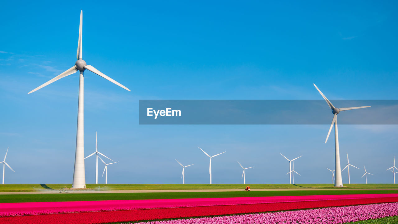 windmill on field against clear sky